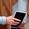 An older adult learning to use a tablet with a tutor