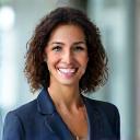 Headshot of a friendly, professional sales consultant, mid-30s, diverse, smiling confidently. Dressed in business casually. Soft focus background.